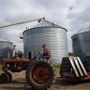 Wade’s Dad driving tractor and grain&nbsp;bins